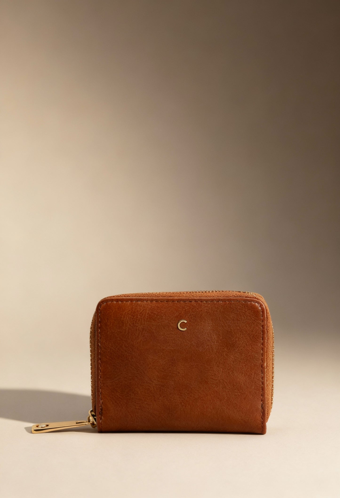 Carrera Jeans LILY-CB7013 brown women’s zip wallet with textured PU finish, displayed in warm studio lighting.