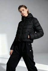 Woman wearing Ciesse MIKALA-P0210D black padded bomber jacket with zip fastening, studio lighting.