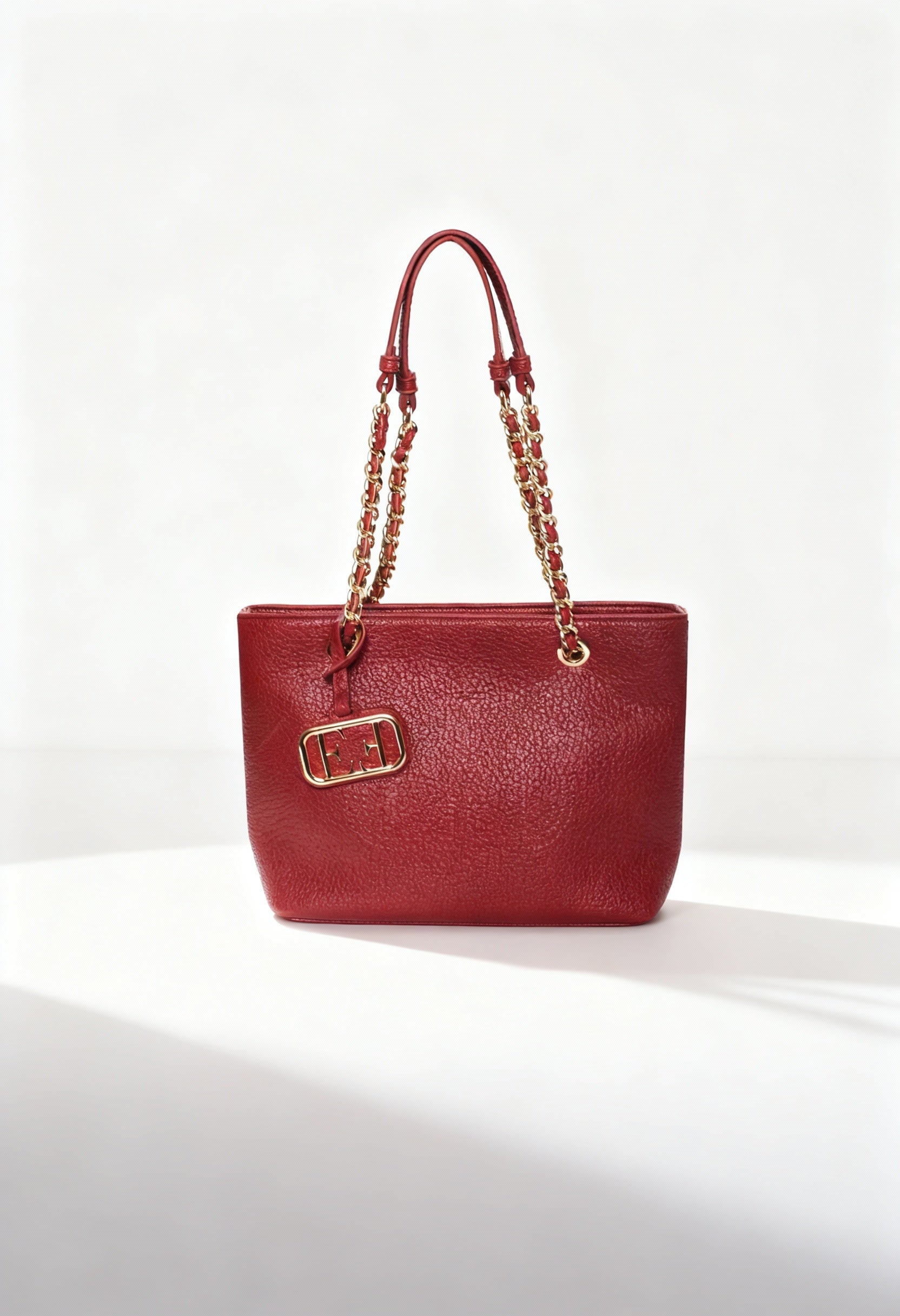 Red Egon Von Furstenberg EVF68102 CLAUDIA shoulder bag with chain handles and logo plaque, shown in studio lighting.