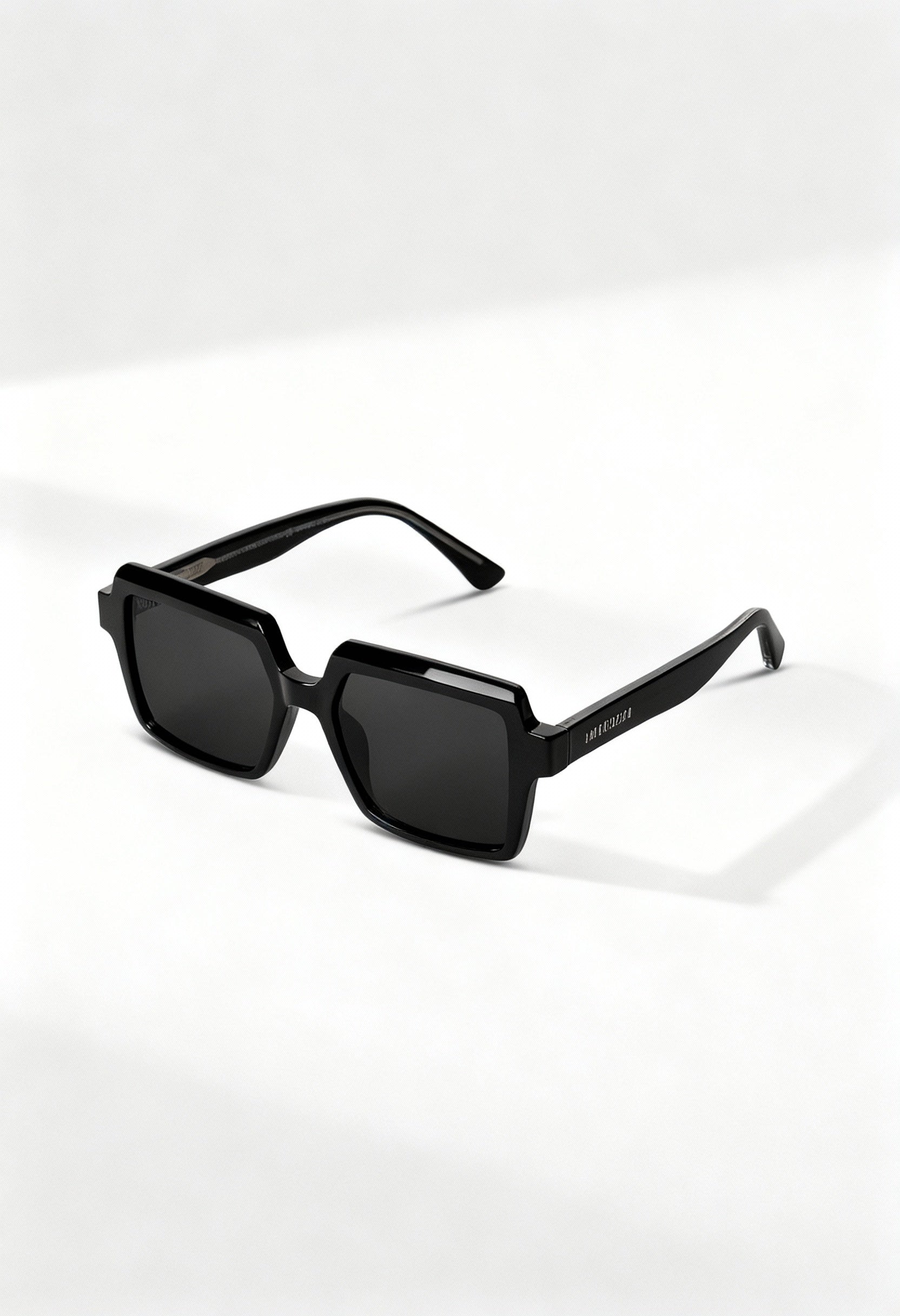 LatenzaZero Echelon unisex sunglasses with black acetate frame and square UV3 lenses, displayed on a white surface under natural light.