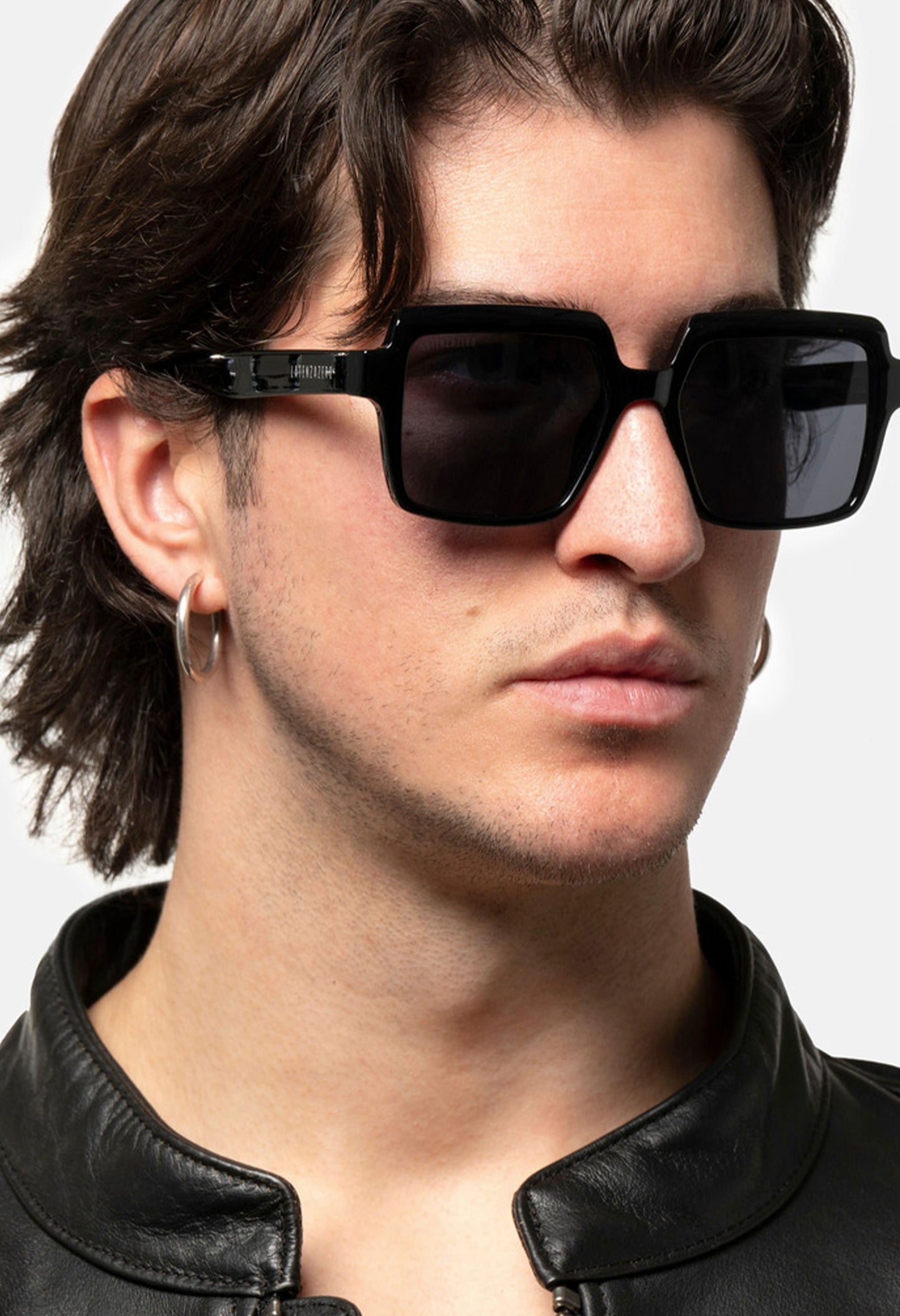 Side profile of male model wearing LatenzaZero Echelon black acetate sunglasses, featuring bold UV3 square lenses.