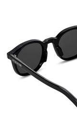 Close-up of LatenzaZero Zenith sunglasses highlighting glossy black acetate finish and UV3 lenses.