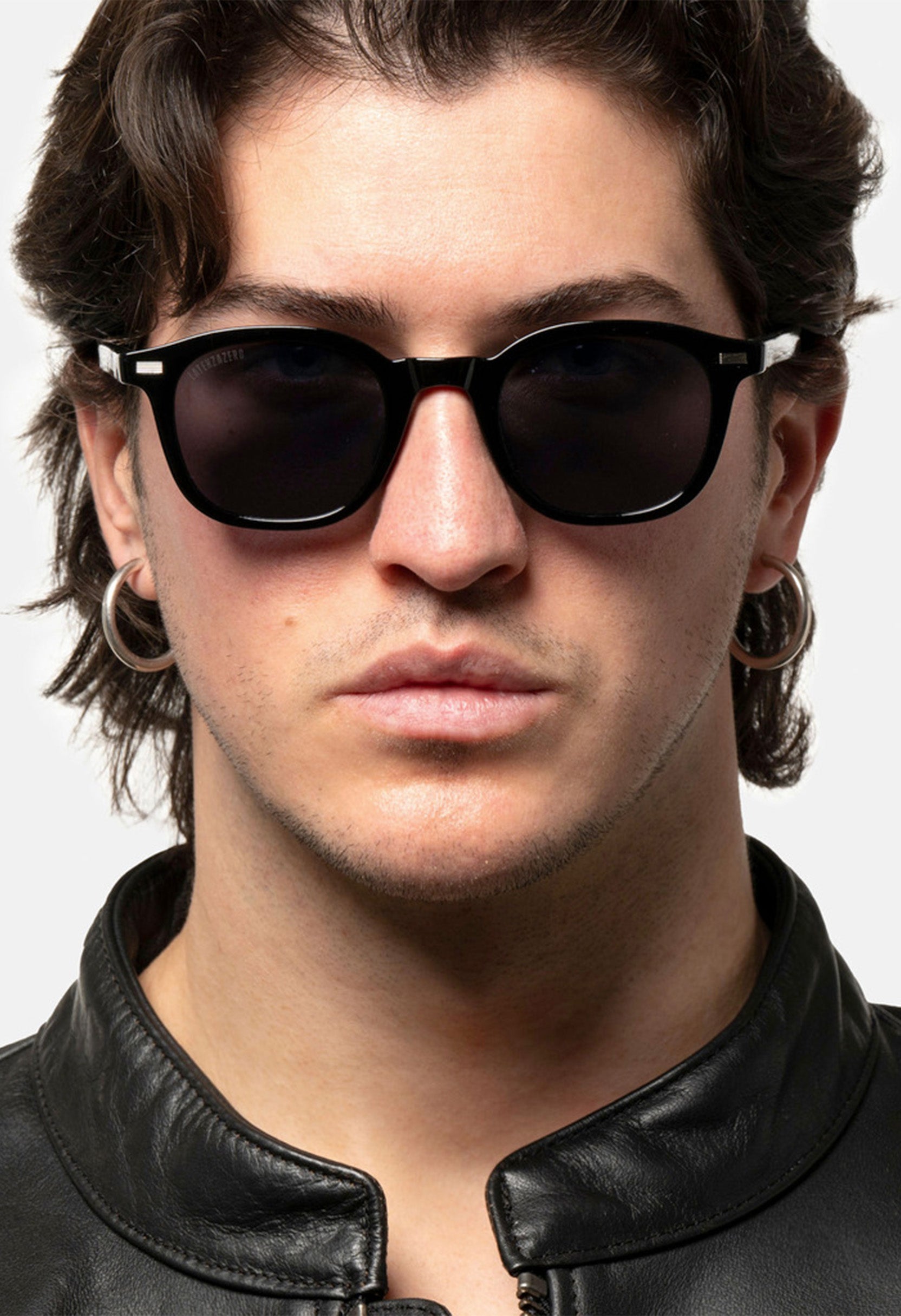 Male model wearing LatenzaZero Zenith sunglasses, black acetate frame and UV3 lenses, luxury unisex fashion look.