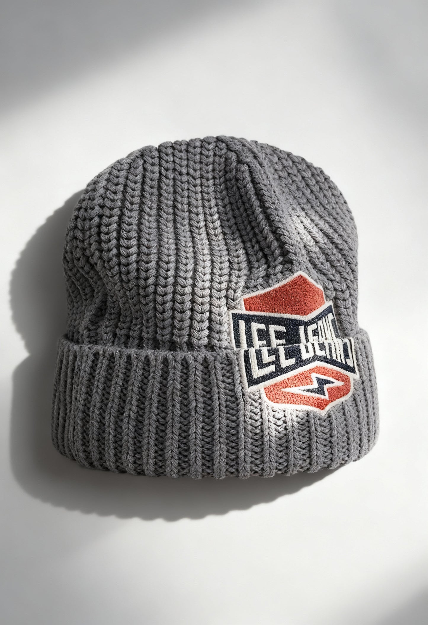 Lee 112358291 grey textured knit unisex beanie hat with bold Lee logo patch, displayed in studio lighting.