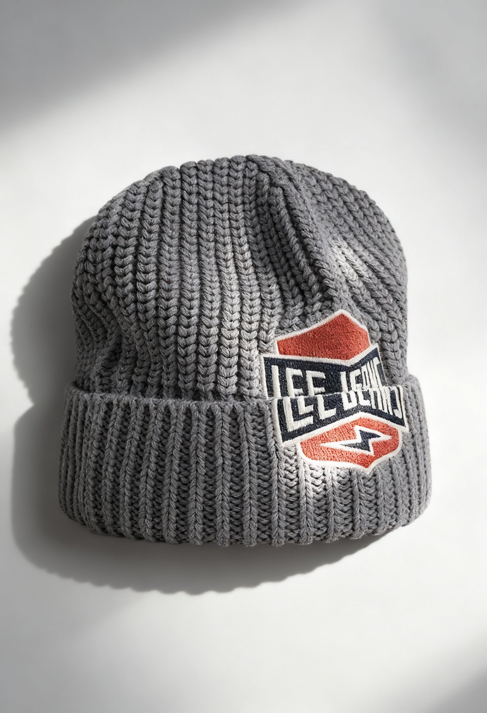 Lee 112358291 grey textured knit unisex beanie hat with bold Lee logo patch, displayed in studio lighting.