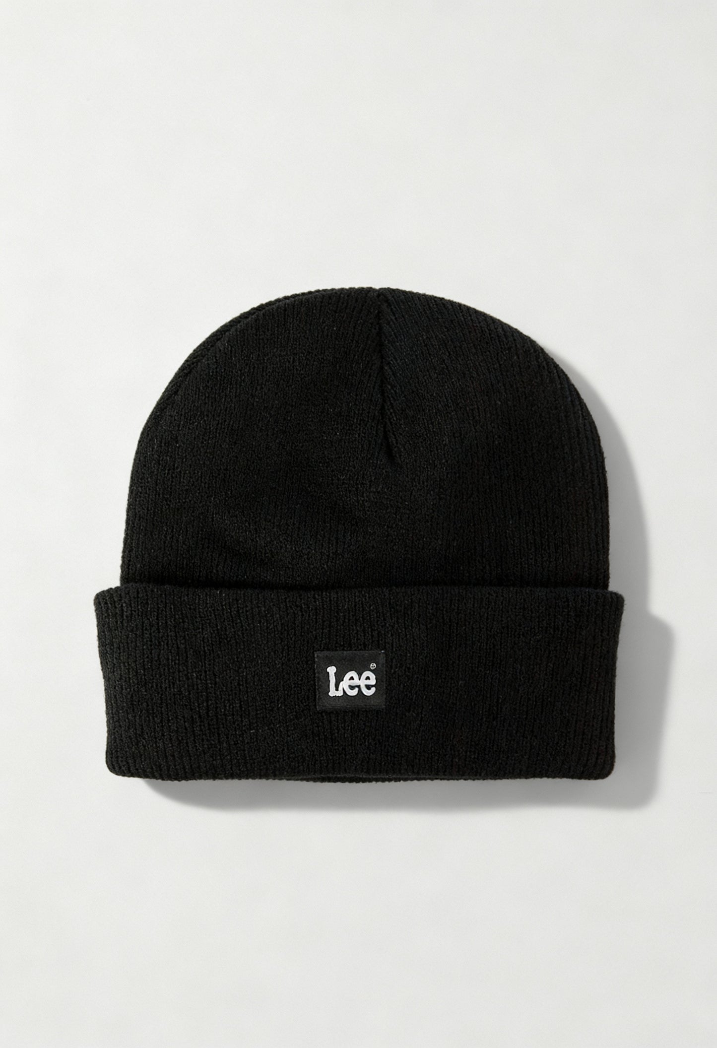 Lee LP594001 black unisex ribbed knit beanie hat with folded cuff and Lee logo, displayed in studio lighting.