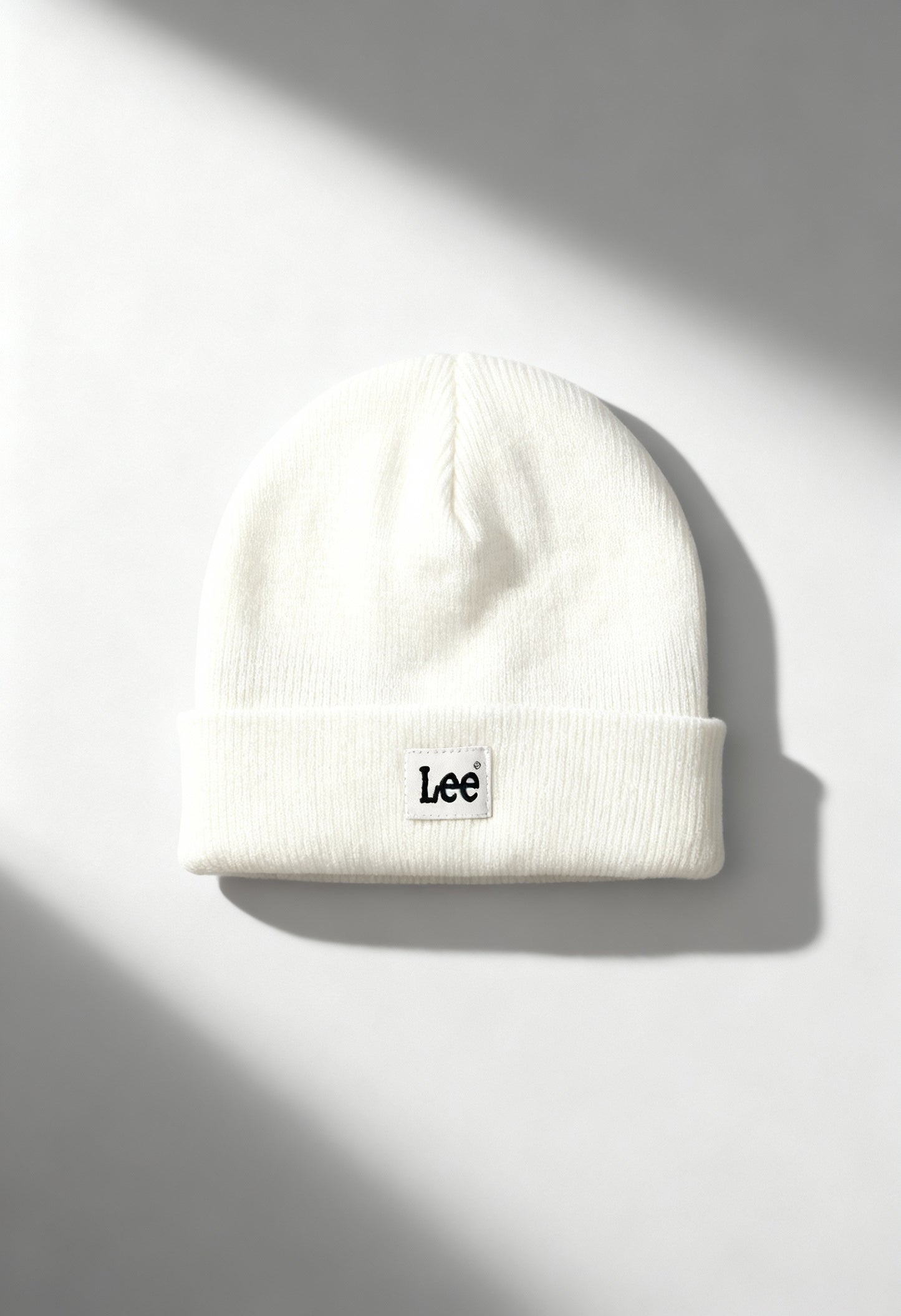 Lee LP5940NQ white unisex ribbed knit beanie hat with folded cuff and Lee logo, shown in bright studio lighting.