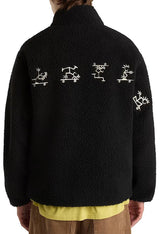 Back view of Vans VN000NDUBLK1 men’s fleece jacket featuring white graphic details across the upper back.