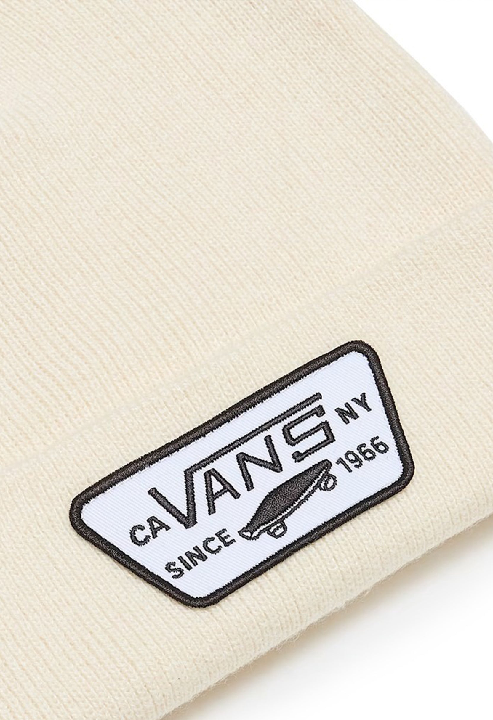 Close-up of Vans VN000UOUDJR1 beanie hat showing Vans NY woven patch on cream knit cuff.