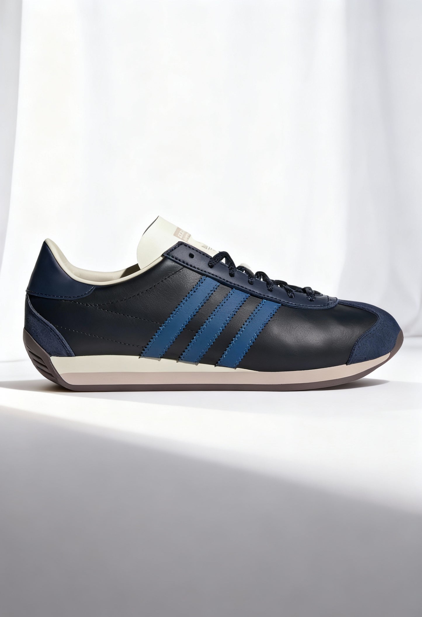 Adidas COUNTRY OG men's heritage sneakers in dark color with white stripes, synthetic leather upper.