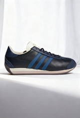 Adidas COUNTRY OG men's heritage sneakers in dark color with white stripes, synthetic leather upper.