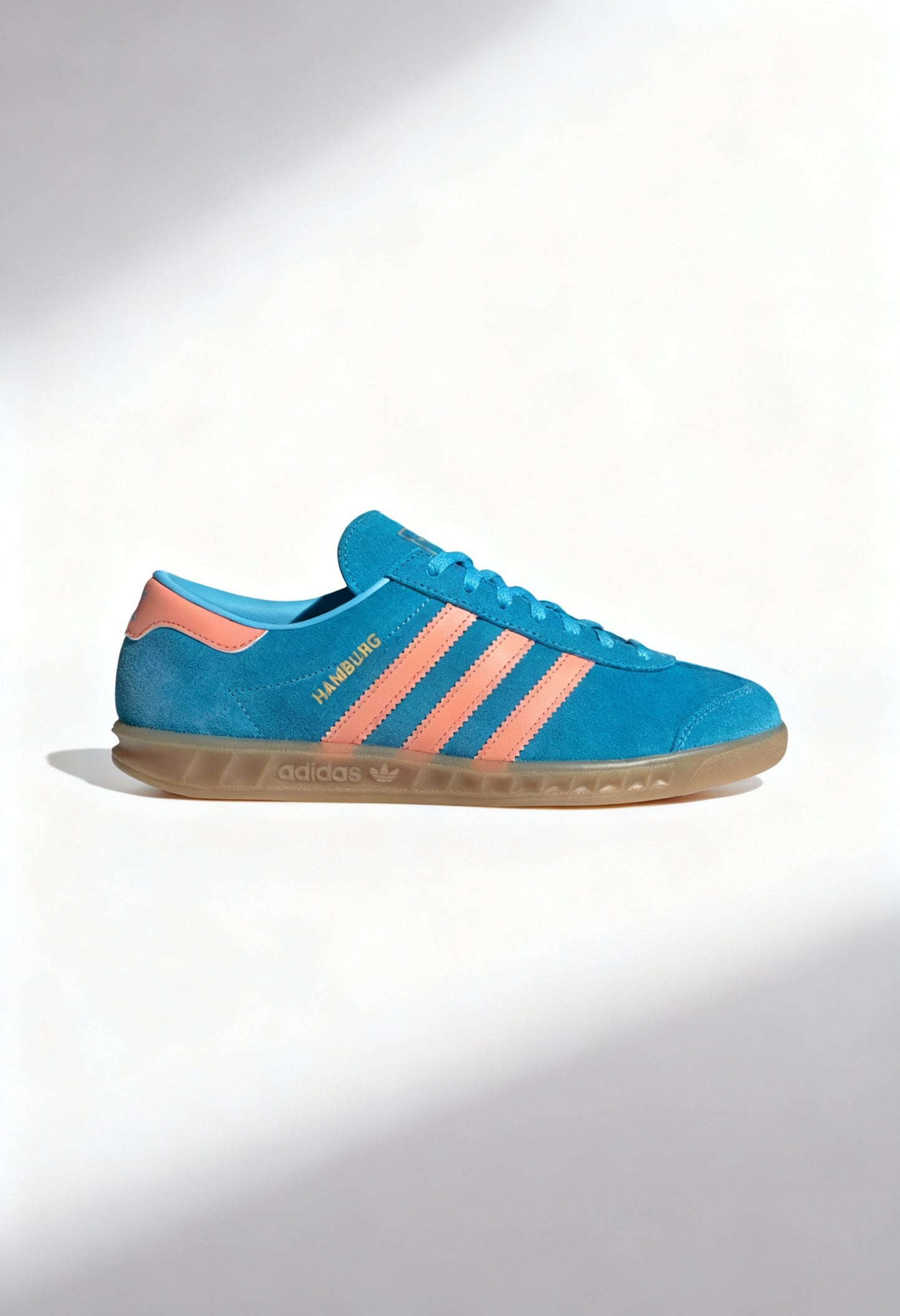 Adidas Hamburg W women's sneakers in blue suede with coral stripes and gum sole.