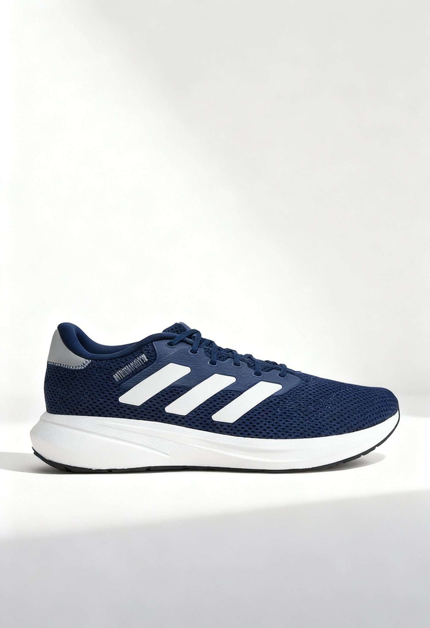 Brand new Adidas Response Runner U sneakers in blue with white 3-stripes side view.