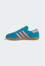 Side profile of an authentic Adidas Hamburg blue sneaker showing the low-top silhouette.