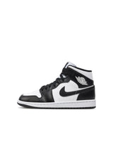 Side profile of authentic black and white Nike Air Jordan 1 Mid shoes highlighting the iconic silhouette.