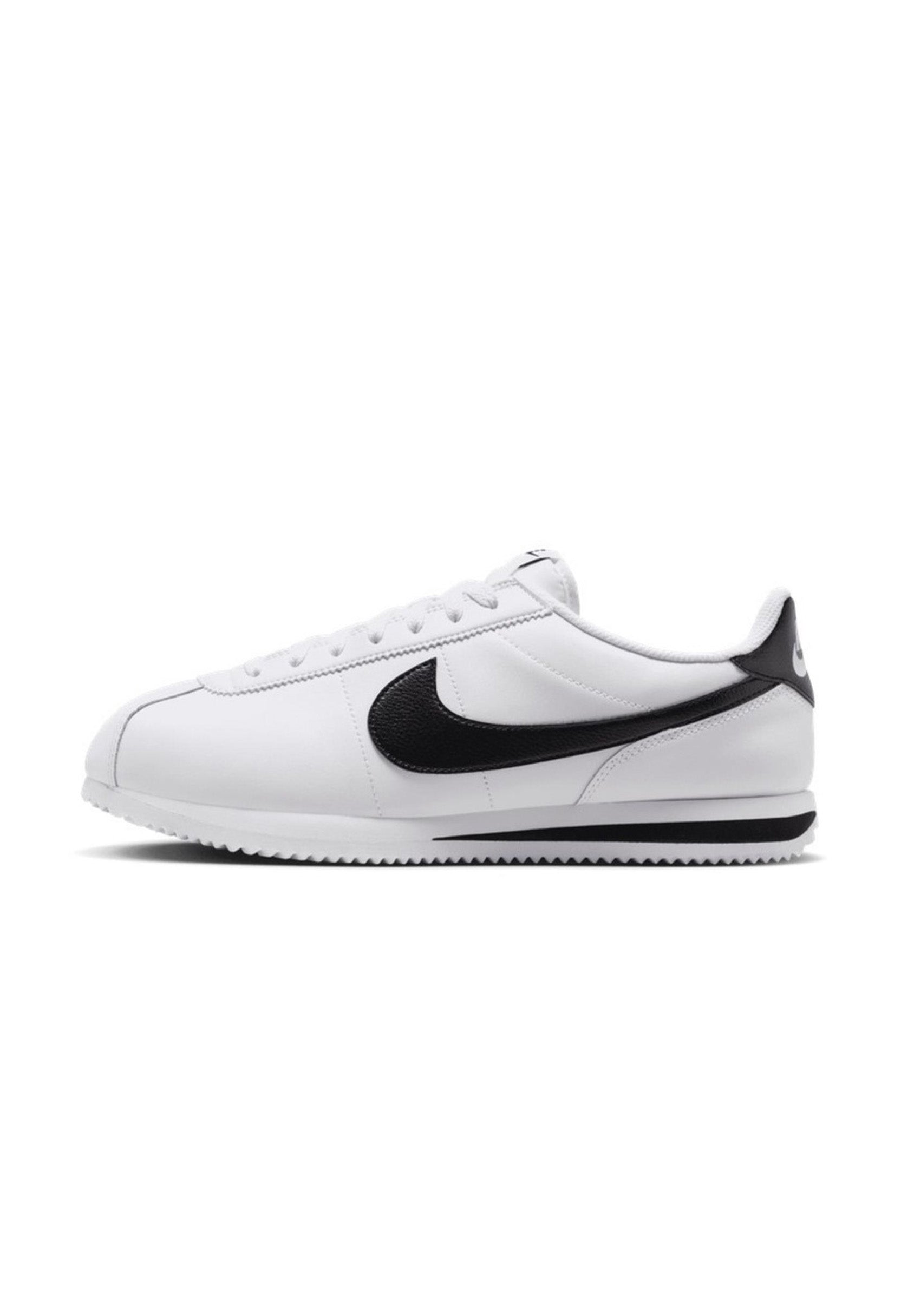 Side profile of authentic white Nike Cortez shoes highlighting the retro silhouette.