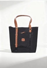 Front studio view of the Bric’s BXG05071-1906603 black nylon shopping bag with brown leather handles.