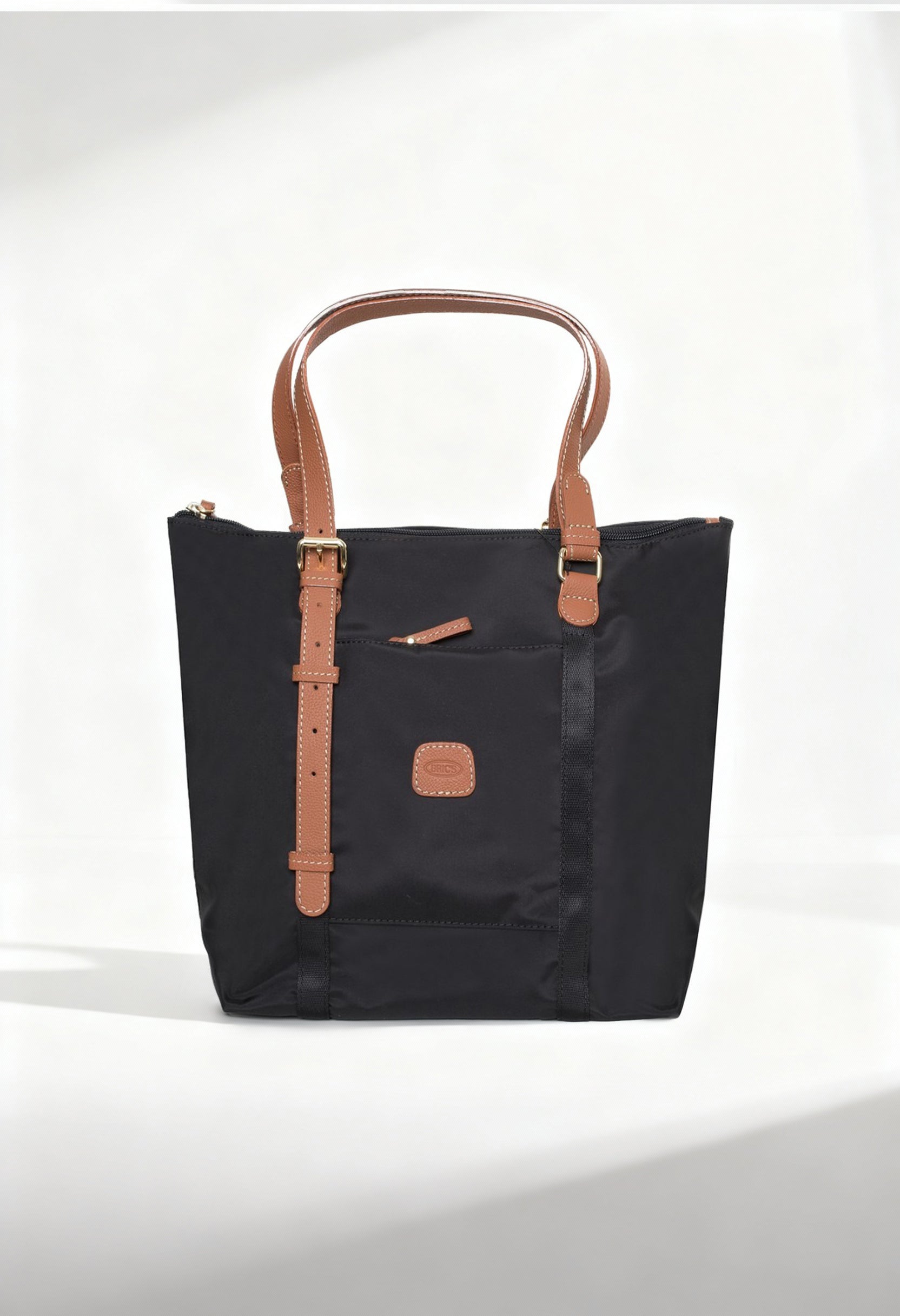 Front studio view of the Bric’s BXG05071-1906603 black nylon shopping bag with brown leather handles.