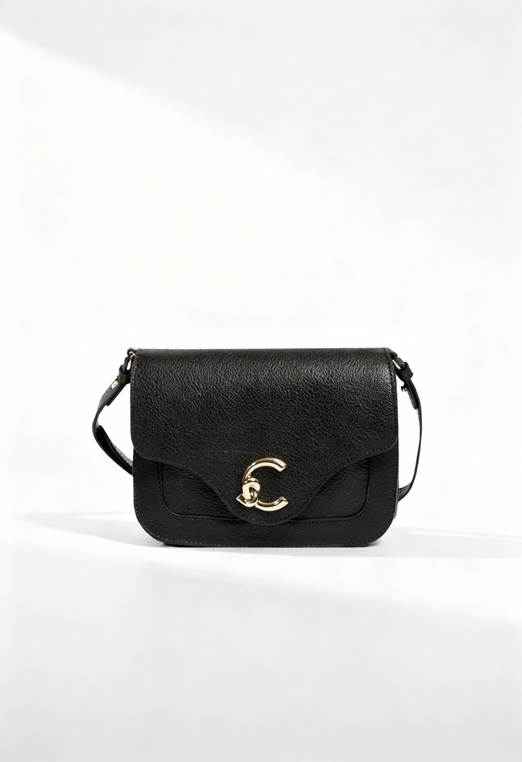 Coccinelle black leather across-body bag, front view showing C-clasp and textured leather.
