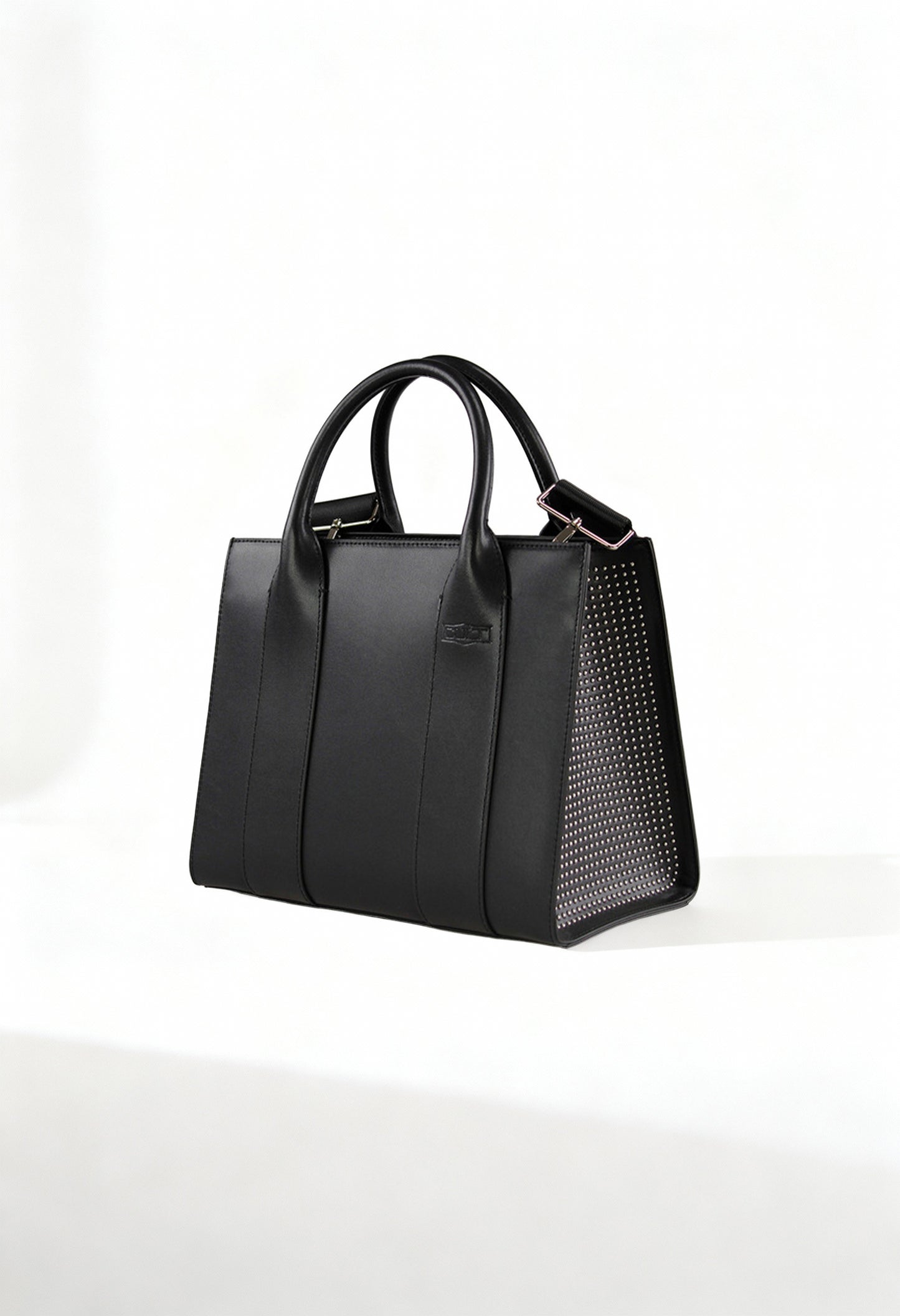 Front angle of the black Cult structured handbag with leather-blend finish and textured side panels.