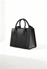 Front angle of the black Cult structured handbag with leather-blend finish and textured side panels.