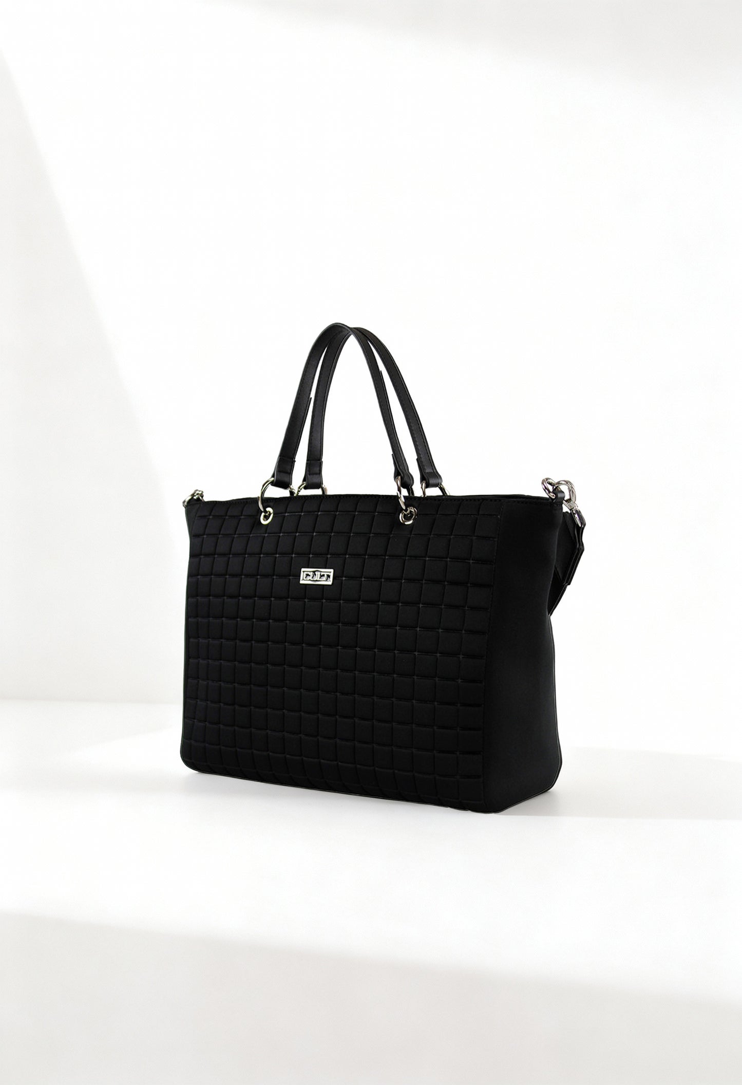Front angle of the black Cult quilted shopping bag with double handles and structured design.