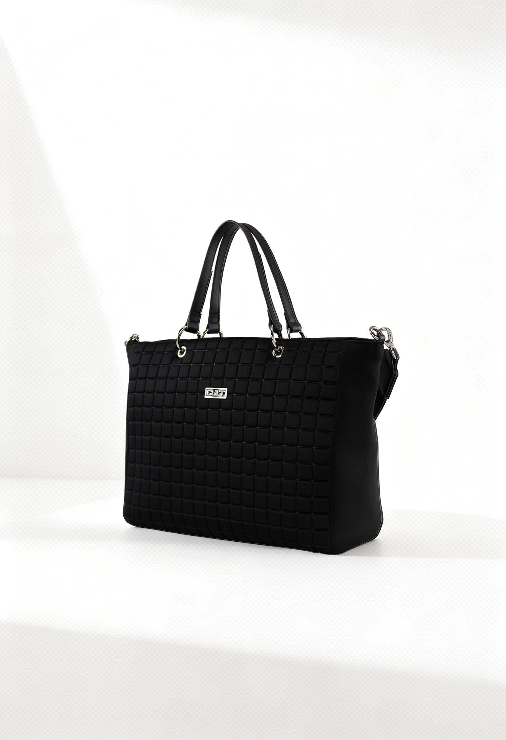 Front angle of the black Cult quilted shopping bag with double handles and structured design.