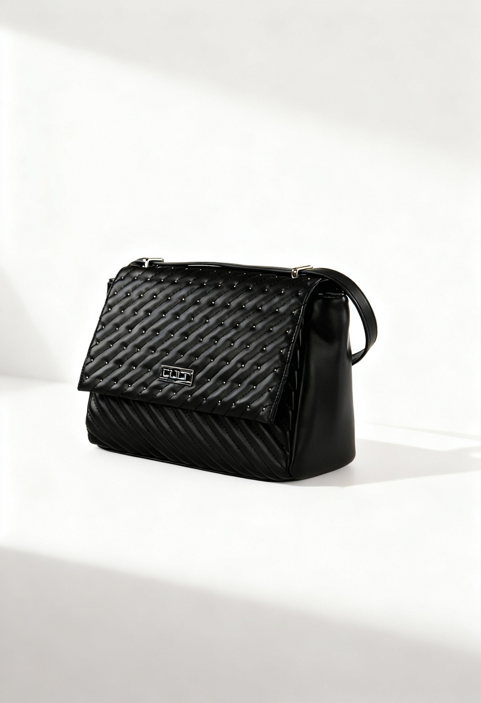 Front angle of the black Cult quilted shoulder bag with flap design and structured silhouette.