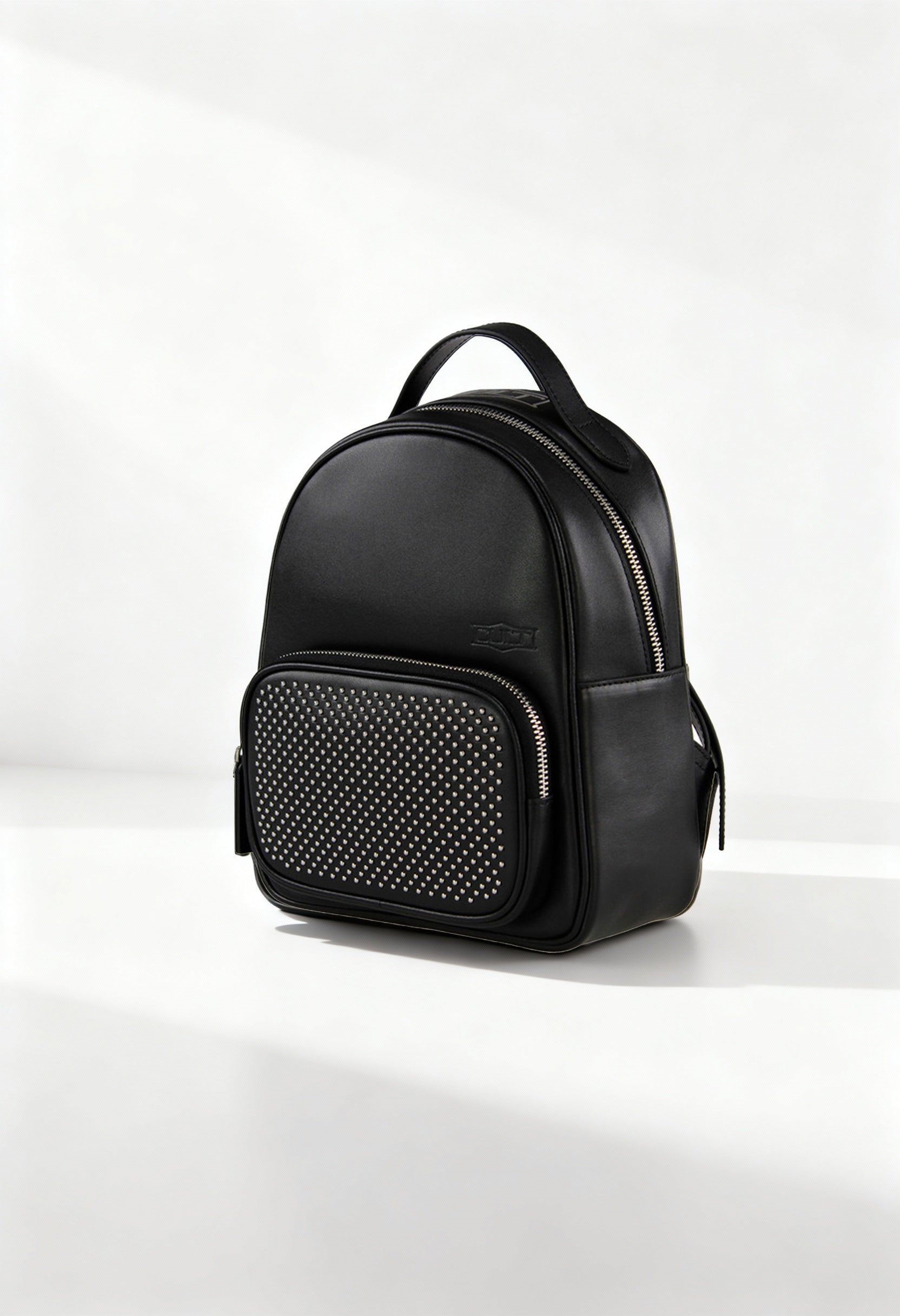 Front angle of the black Cult women’s backpack featuring a studded front pocket and structured design.
