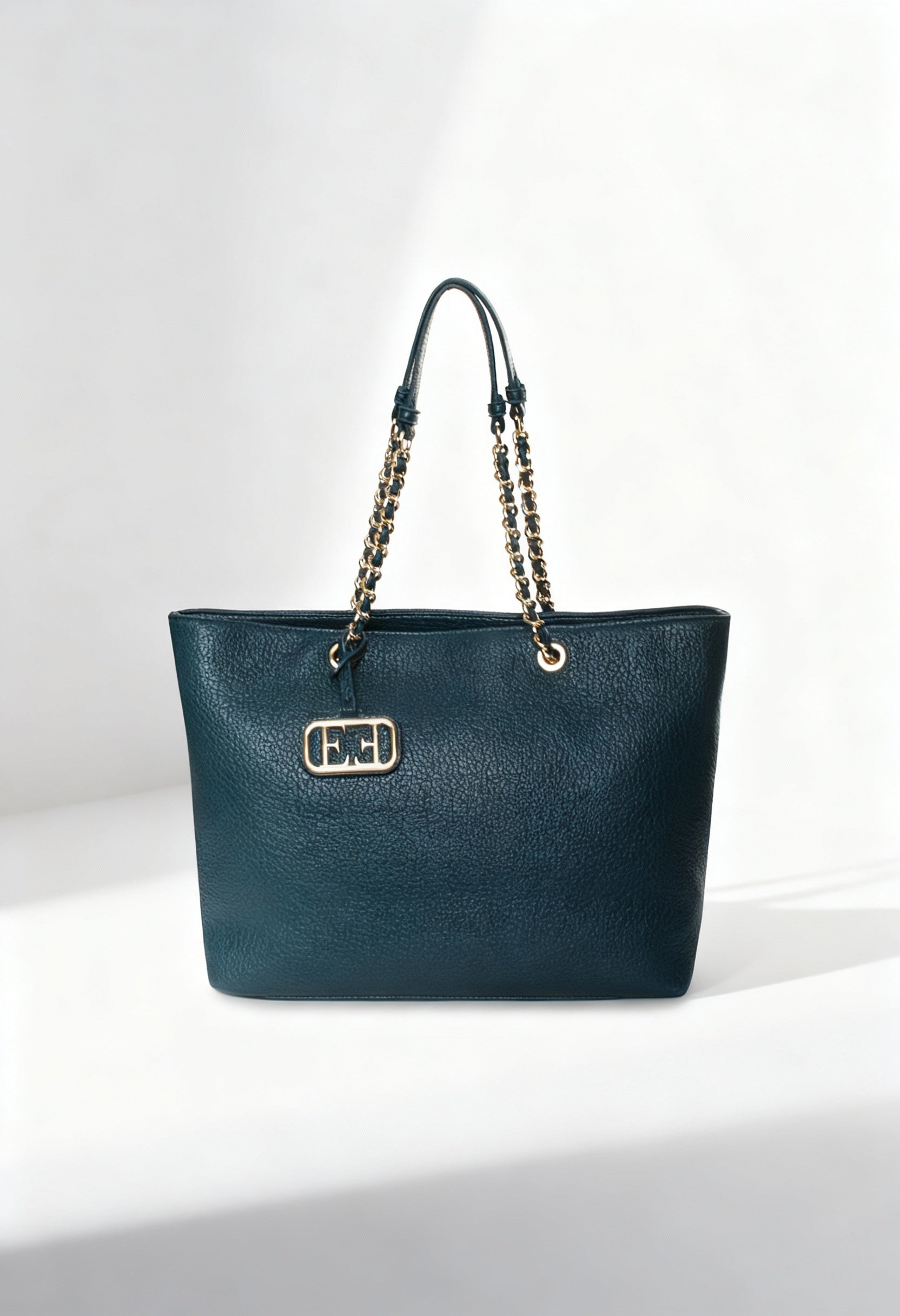 Front view of the dark teal Noemi woman shoulder bag with chain handles on a light background.
