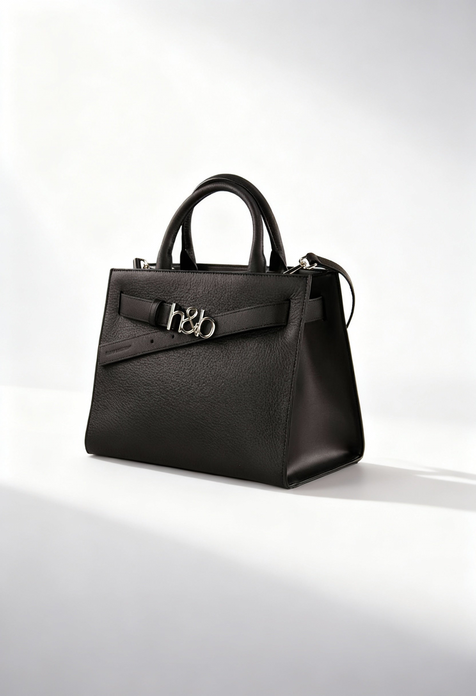 Front angled studio shot of the Harmont&Blaine H4DPWH510042 black structured handbag with metal logo detail.