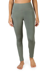 High-quality stretchy green activewear leggings, full-length shot, worn by model.