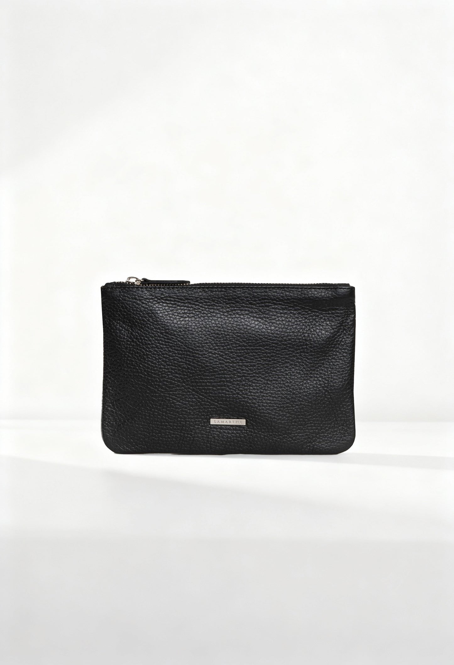 Front view of the Lamarthe TRE102 black textured leather clutch with metallic logo plate.