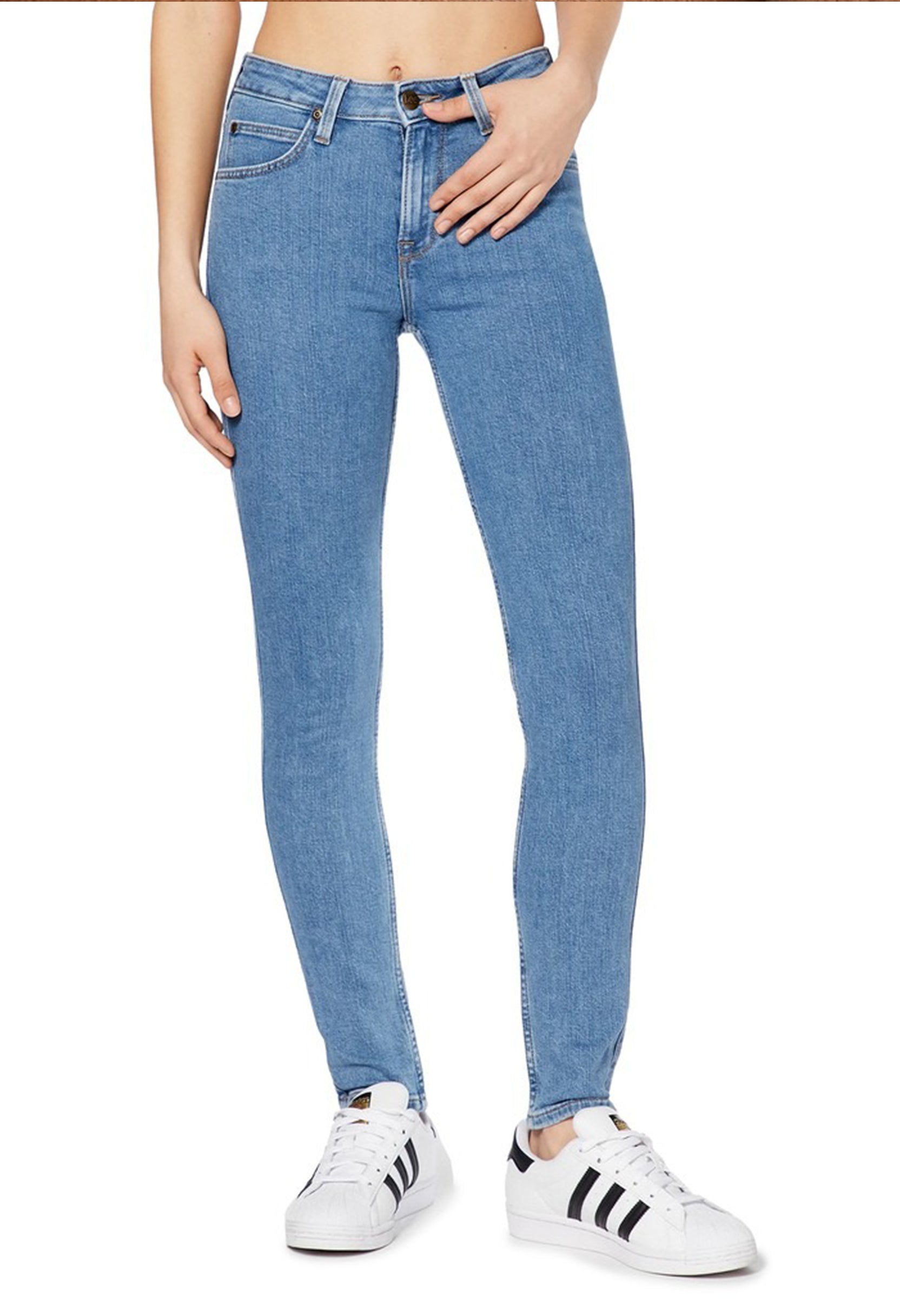 Studio front shot of a woman wearing the light blue Lee L626FAB38 skinny jeans.