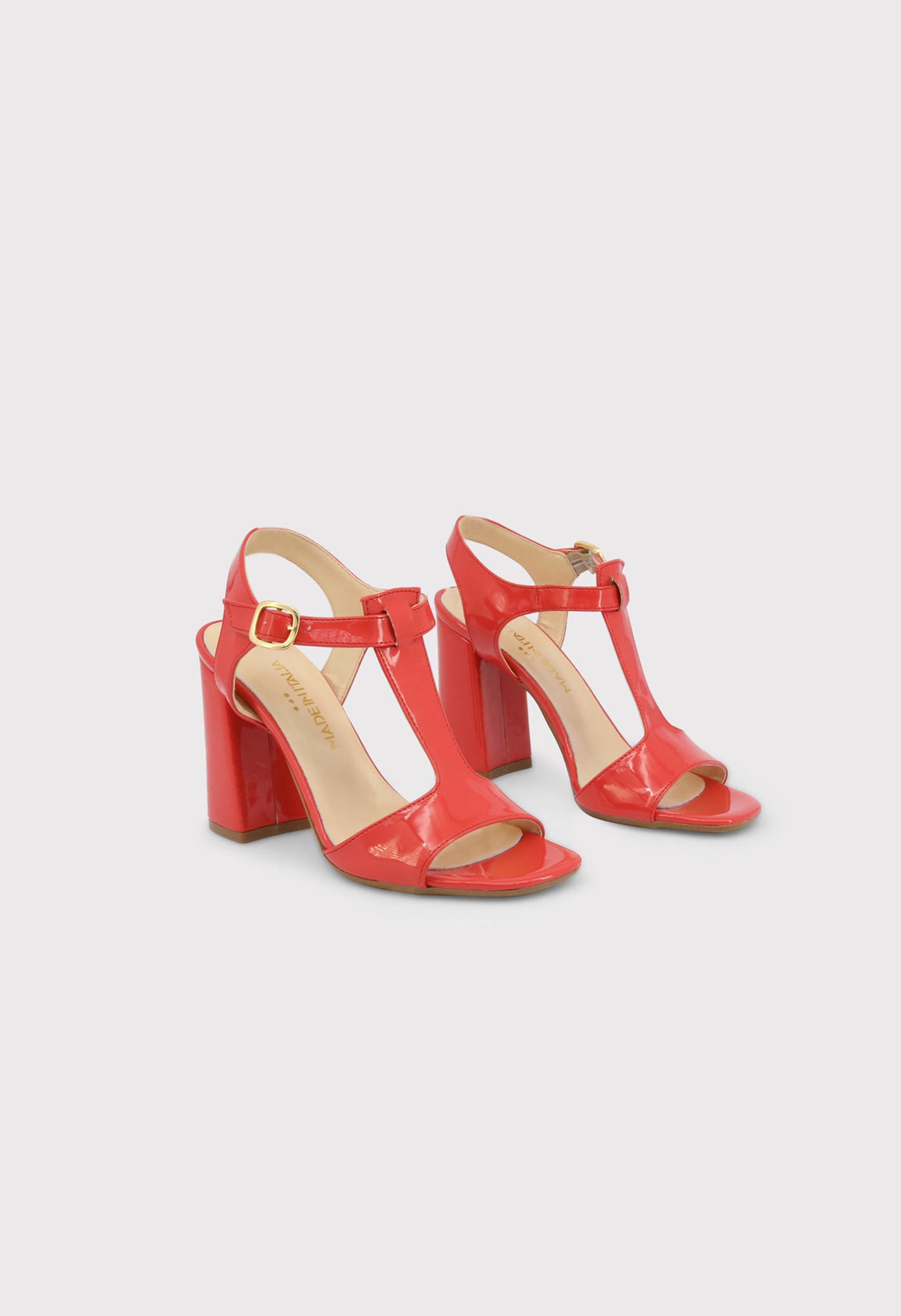 Front pair view of the ARIANNA red patent leather sandals showing the open toe and ankle strap design.