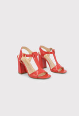 Front pair view of the ARIANNA red patent leather sandals showing the open toe and ankle strap design.