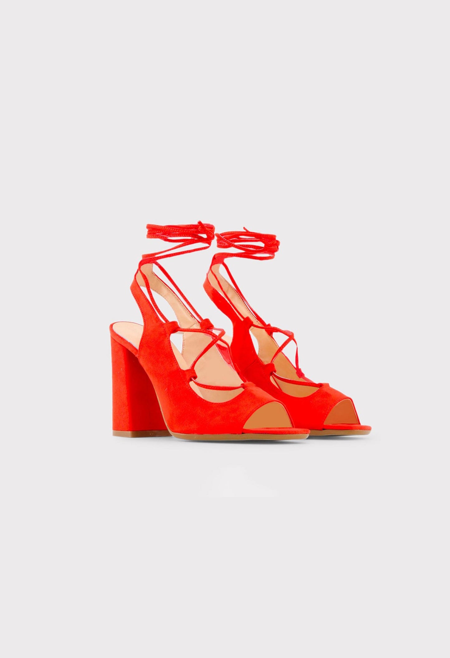 Side view of the red LINDA lace-up sandals showing the block heel and open-toe design.