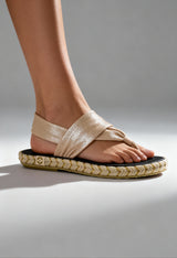 On-foot view of the beige Nalho fabric flip-flop sandals with braided sole and cross-strap design.
