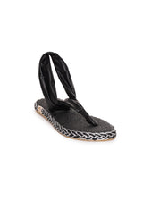 Three-quarter angle of the black Nalho NA0035 sandals highlighting the sling-back design and textured sole.