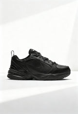 Brand new Nike Air Monarch IV men's training shoes in triple black side view.