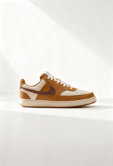 Brand new Nike Court Vision Low Next Nature women's sneakers in tan and brown side view.