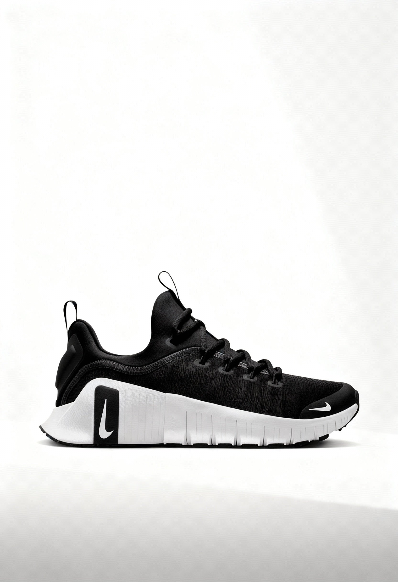 Brand new Nike Free Metcon 6 women's training shoes in black and white side view.