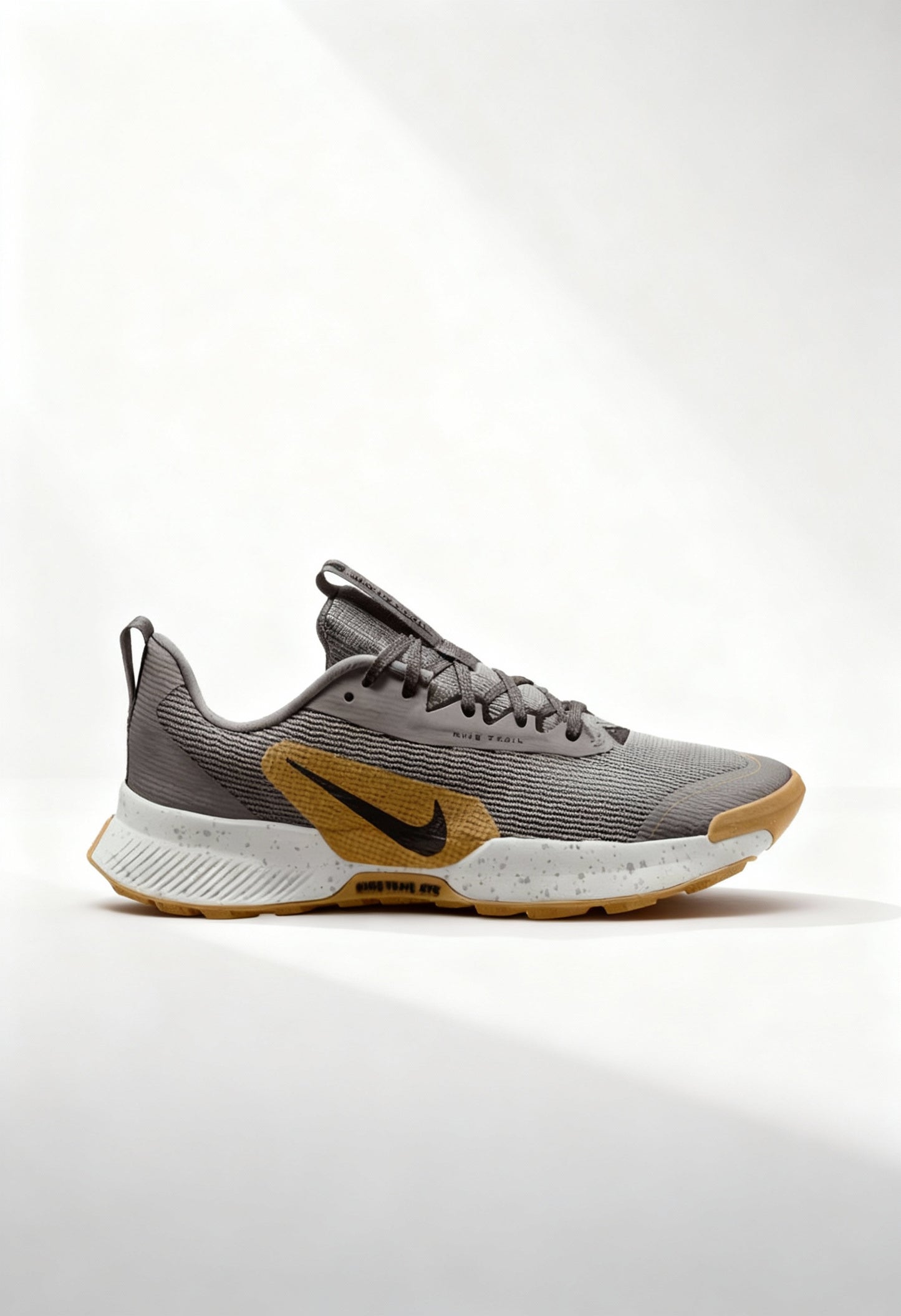 Brand new Nike Juniper Trail 3 women's trail running shoes in grey and gold side view.