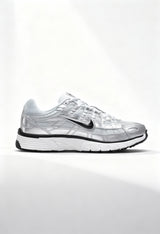 Brand new Nike P-6000 women's sneakers in metallic silver and white side view.