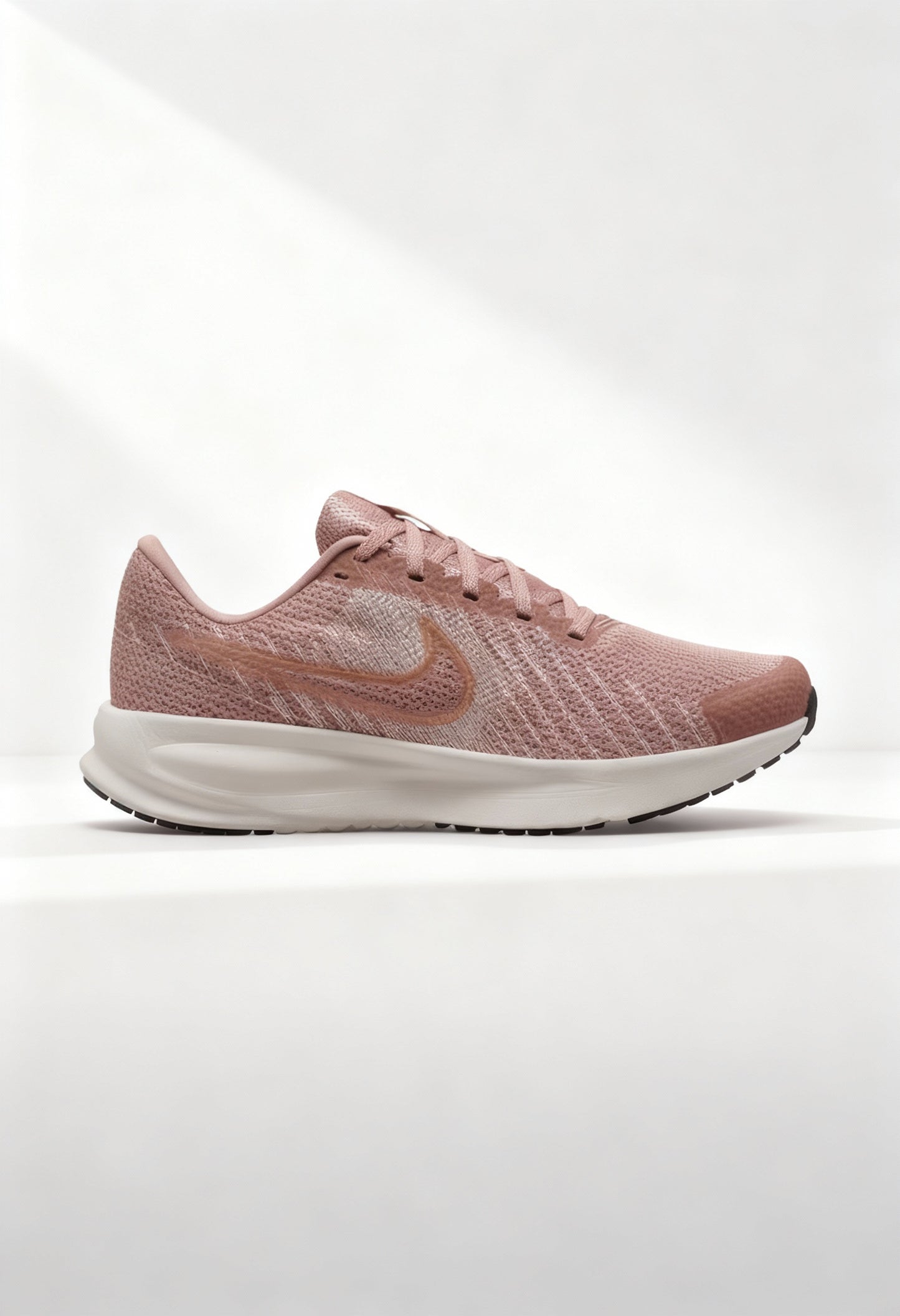Brand new Nike Run Defy women's running shoes in mauve pink side view.