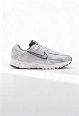 Brand new Nike Zoom Vomero 5 women's sneakers in silver and white side view.