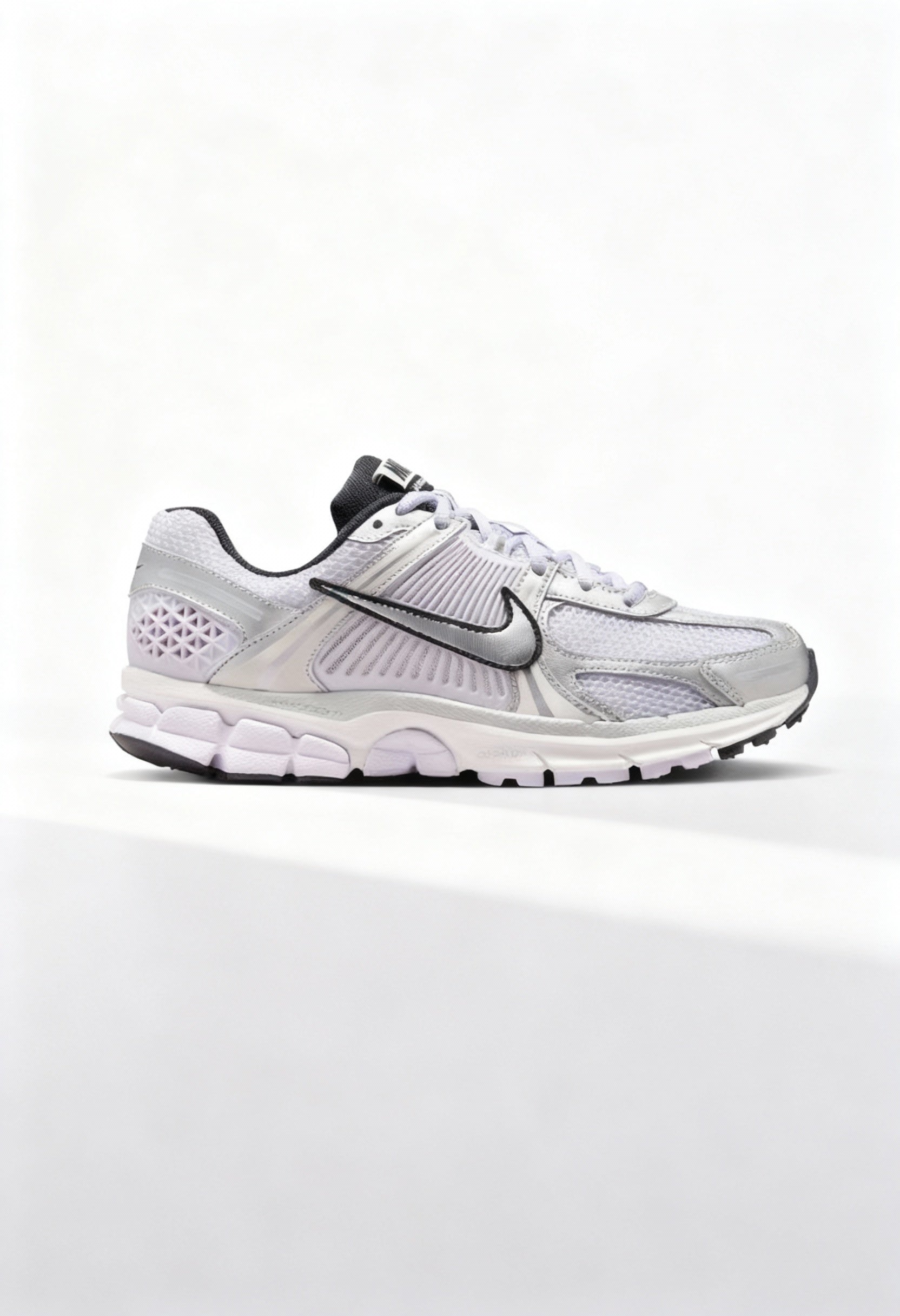 Brand new Nike Zoom Vomero 5 women's sneakers in silver and white side view.