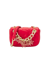 Side angle view of the red crossbody bag showing its slim structure and gold chain detail.
