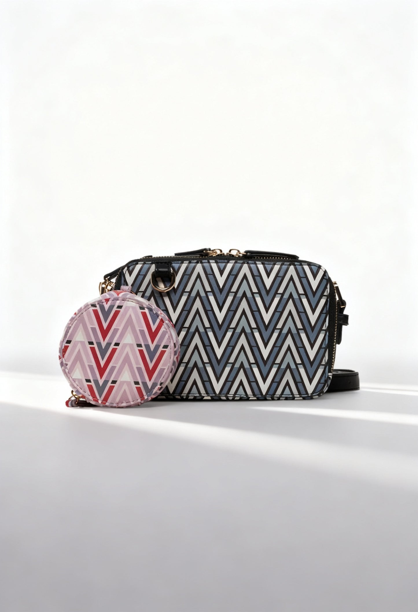 Front angled view of the Valentino TONIC-VBS69904 patterned black crossbody bag with removable coin pouch.