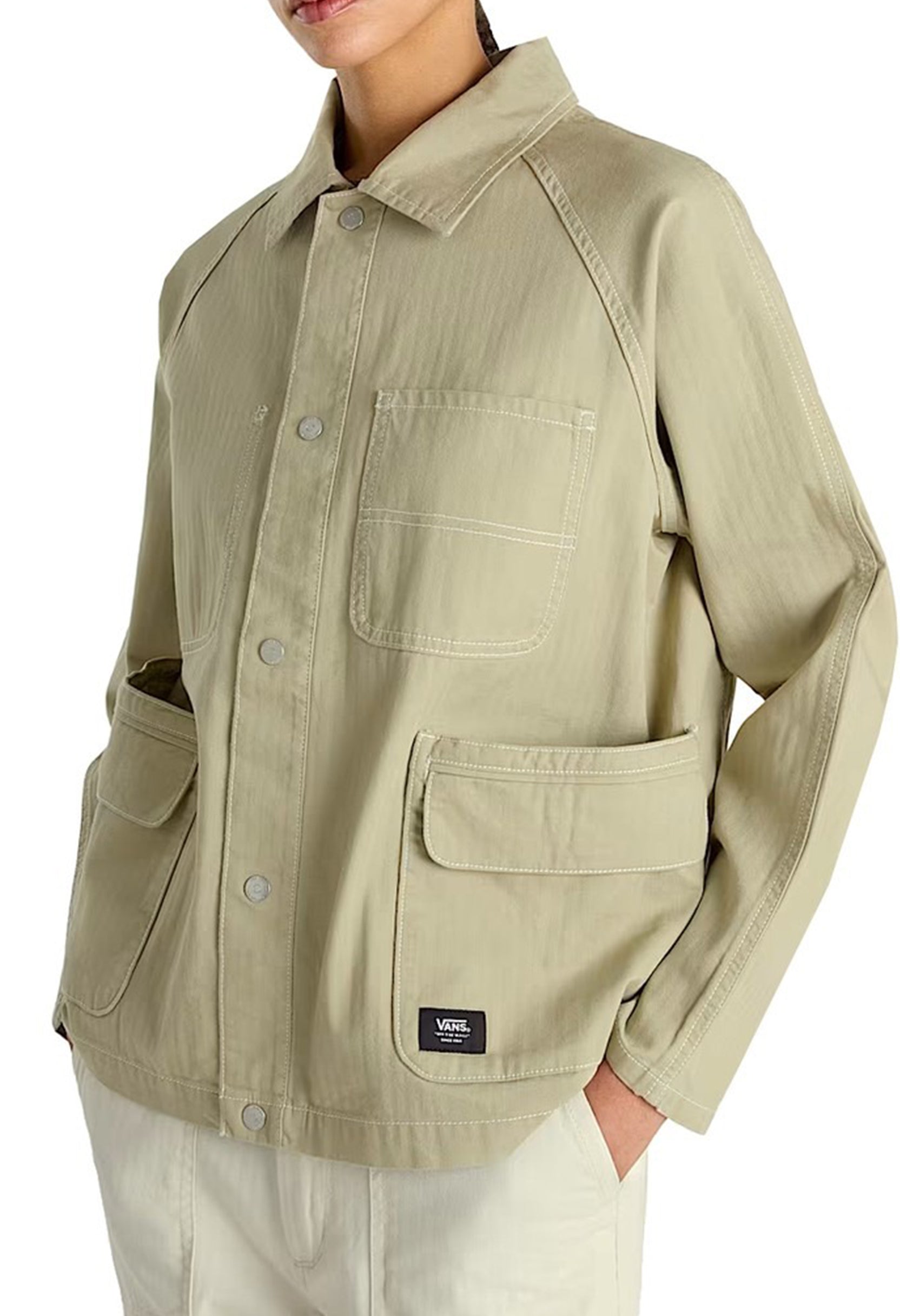 Front view of the beige Vans VN000HJRD3Z1 jacket showing pockets and button closure.